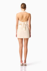Blonde model wearing CURAAE Ceres Halter Top & Mini Skirt Set In White back pose