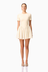 Brunette model wearing Delia Short Sleeve Mini Dress in Cream front shot