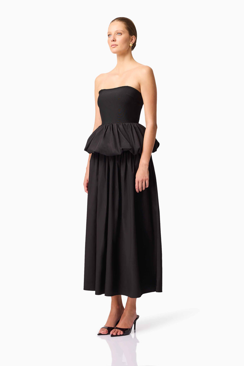 Brunette model wearing Delia Top & Skirt Set in Black side shot