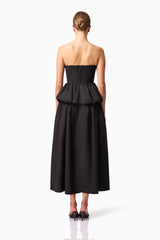 Brunette model wearing Delia Top & Skirt Set in Black back shot