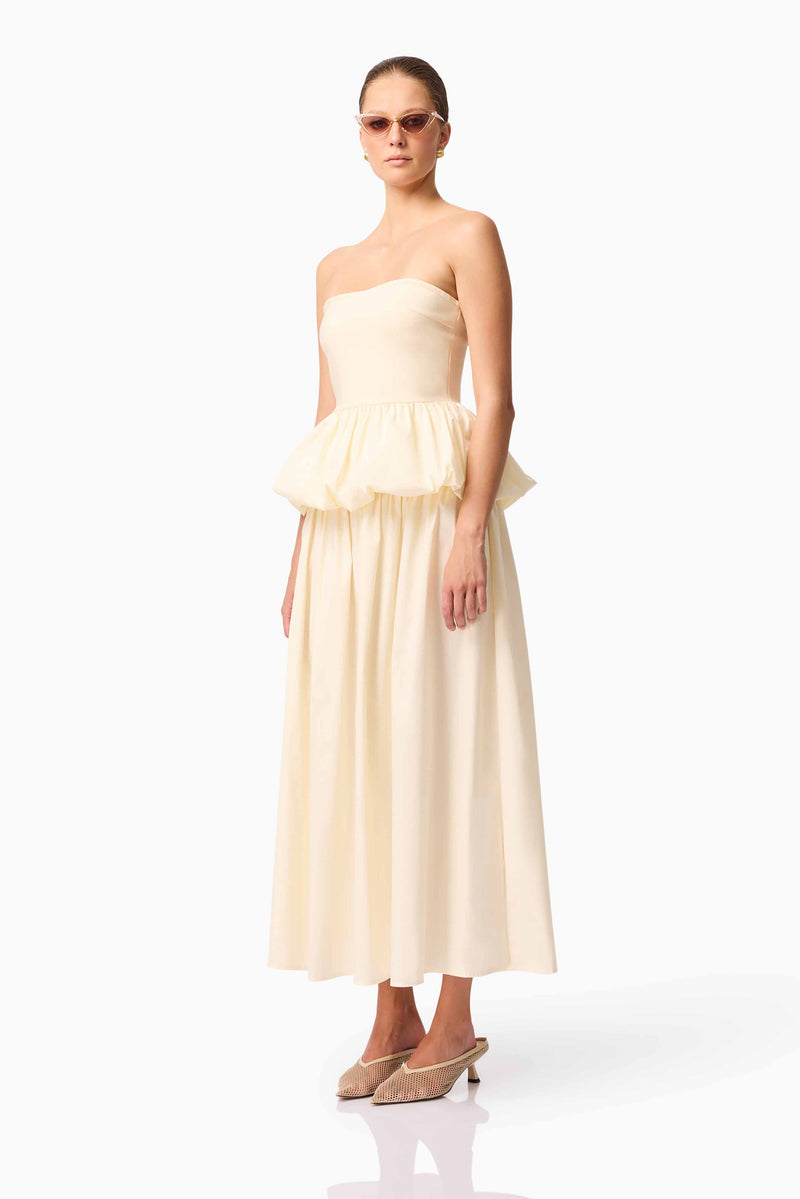 Brunette model wearing Delia Top & Skirt Set in White side shot