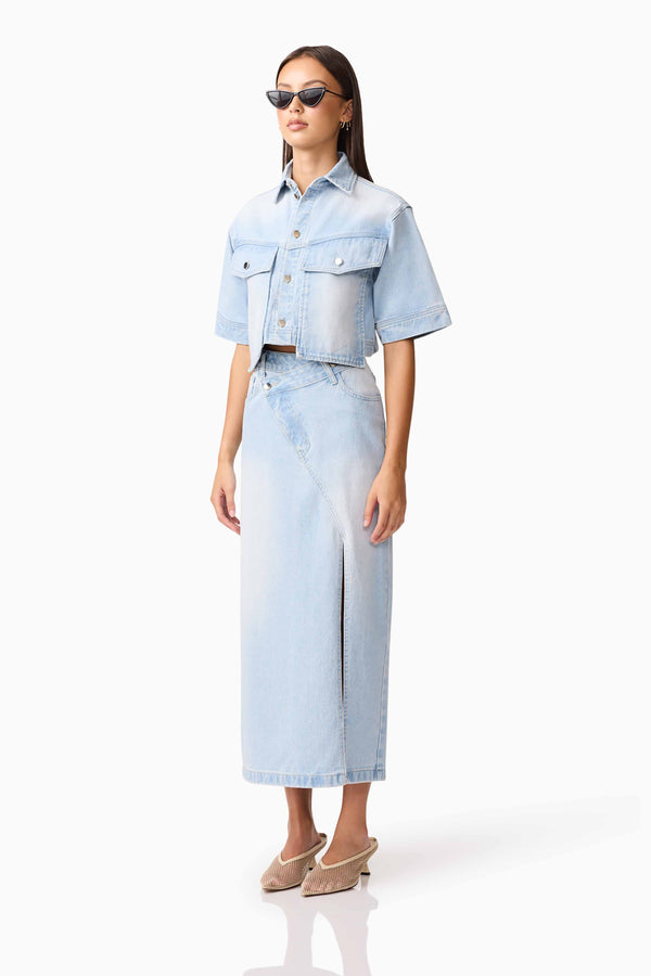 Brunette model wearing Silvie Denim Top & Skirt Set side shot