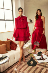 Model wearing the CURAAE Zanetta Long Sleeve Mini Dress in Berry Red to a christmas party 