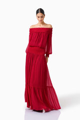 CURAAE Zanetta Off Shoulder Top & Maxi Skirt Set in Berry Red with long sleeves & off the shoulder posed looking down front 