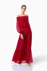 CURAAE Zanetta Off Shoulder Top & Maxi Skirt Set in Berry Red with long sleeves & off the shoulder posed walking front 