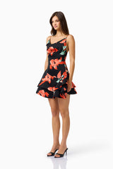 Brunette model wearing the CURAAE Maelis Cowl Neck Mini Dress in Black & Red Floral side shot