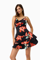Brunette model wearing the CURAAE Maelis Cowl Neck Mini Dress in Black & Red Floral close up hand on hip shot