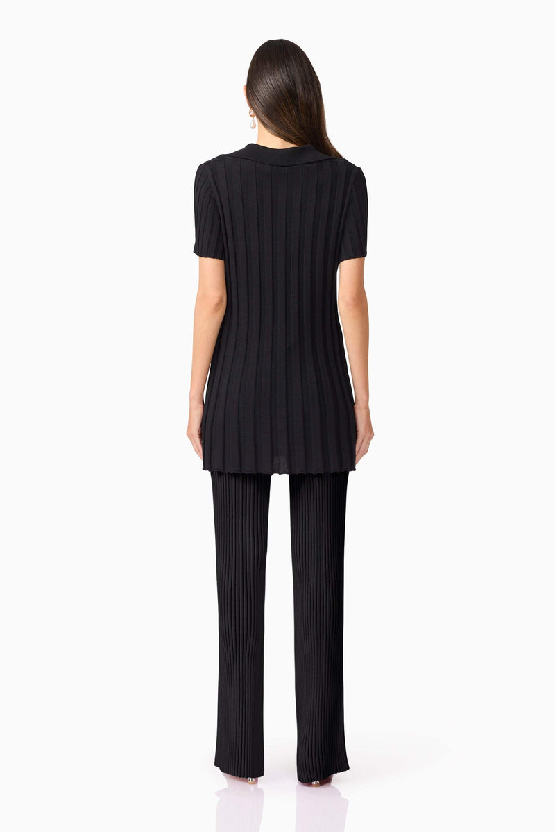 Brunette model wears ANNABELLE KNIT SHIRT back view