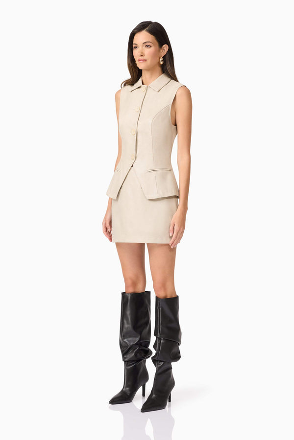 Brunette model wearing Malia Leather Vest In Beige side shot