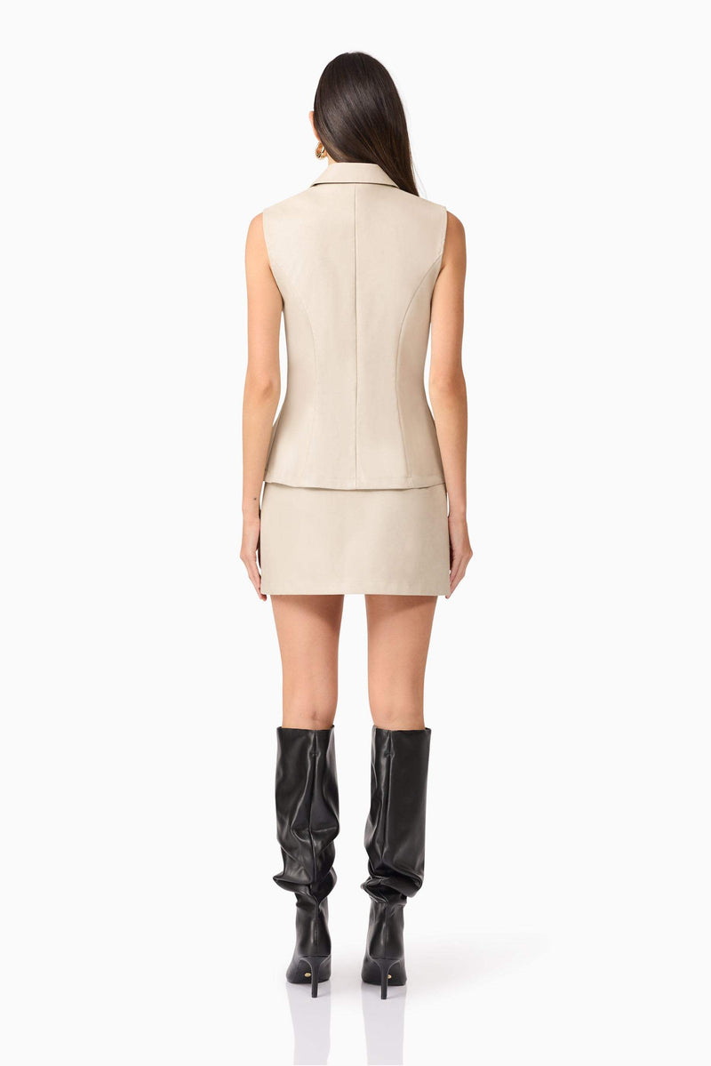 Brunette model wearing Malia Leather Vest In Beige back shot
