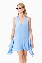 A blonde model wearing a blue mini dress close up shot