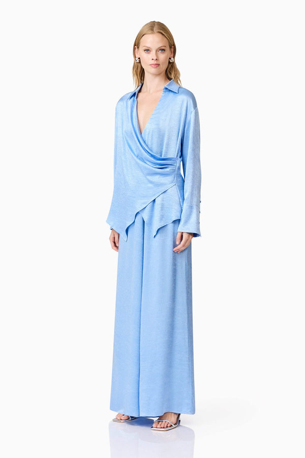 Blonde model wearing Fluer Satin Shirt In Blue side shot