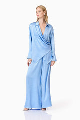 Blonde model wearing Fluer Satin Shirt In Blue posed shot
