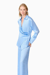 Blonde model wearing Fluer Satin Shirt In Blue close up shot