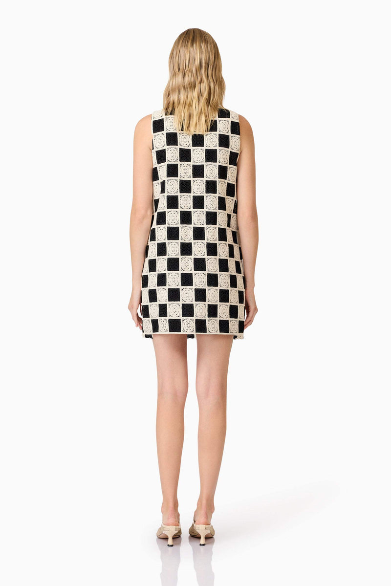 Blonde model wearing  Soho Crochet Mini Dress in Black & White back shot