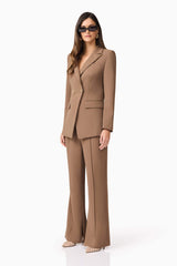 Brunette model wearing Sandy Suit Trouser In Brown side shot