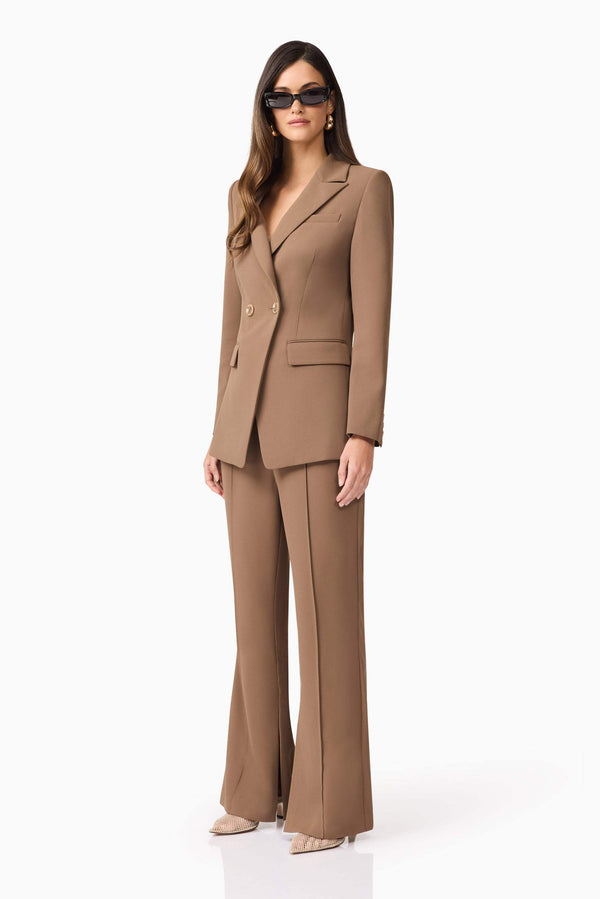 Brunette model wearing Sandy Suit Trouser In Brown side shot