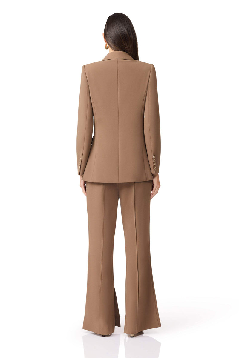 Brunette model wearing Sandy Suit Trouser In Brown back shot