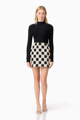 Blonde model wearing Amyra Textured Stretch Top In Black posed shot