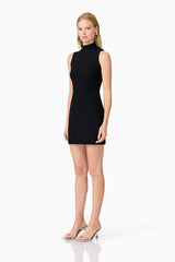 Blonde model wearingAmyra Textured Stretch Mini Dress In Black side shot
