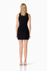 Blonde model wearing Amyra Textured Stretch Mini Dress In Black back shot