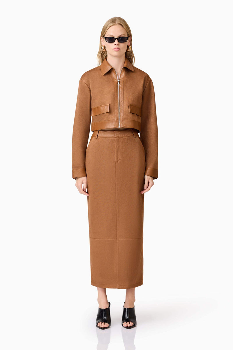 Blonde model wearing Aroha Suede Midi Skirt In Brown front shot