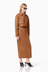 Blonde model wearing Aroha Suede Midi Skirt In Brown side posed shot