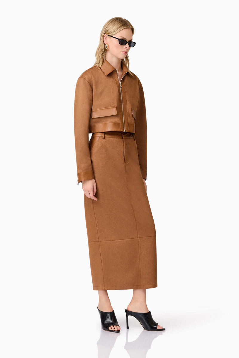 Blonde model wearing Aroha Suede Midi Skirt In Brown side posed shot