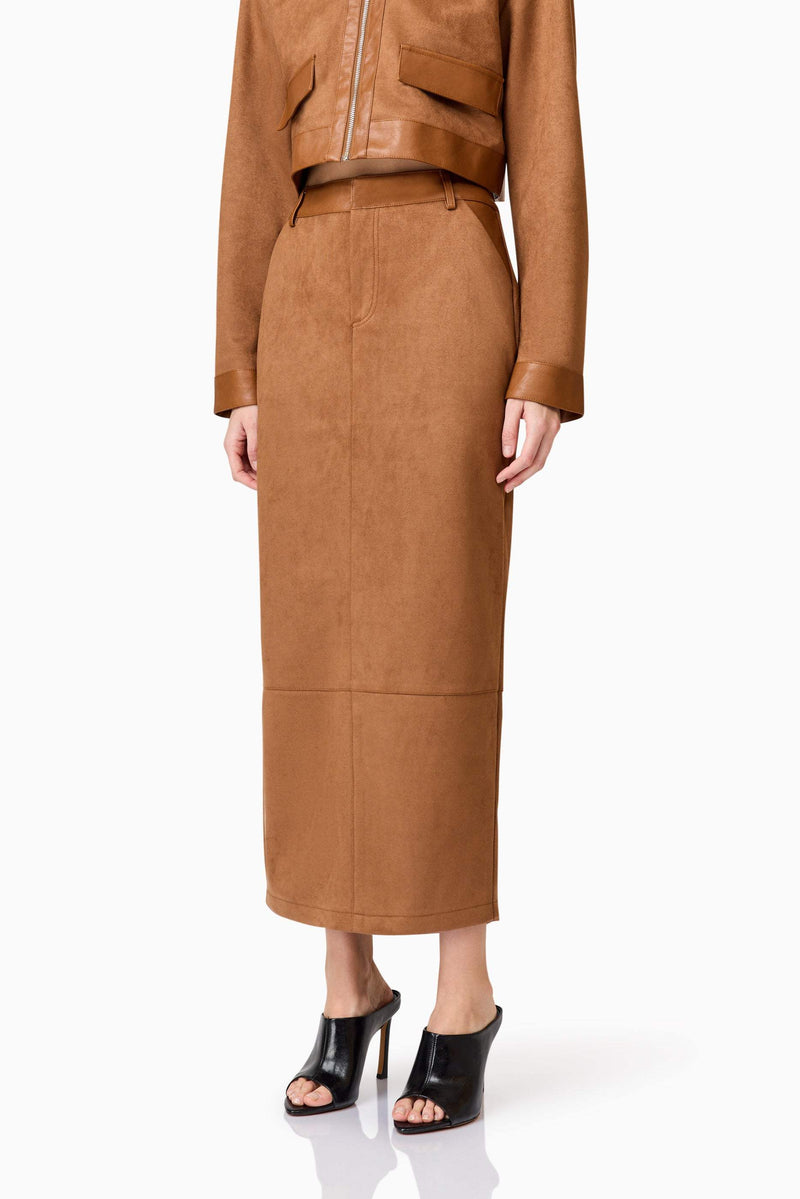 Blonde model wearing Aroha Suede Midi Skirt In Brown detail shot