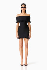 Brunette woman wearing the CURAAE Catiana Mini Dress in Black front shot