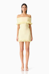 Brunette woman in the CURAAE Catiana Mini Dress in Yellow front shot