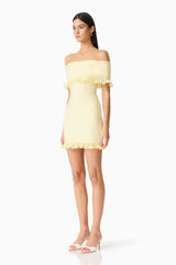 Brunette woman in the CURAAE Catiana Mini Dress in Yellow side shot