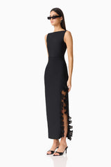 Brunette woman in the CURAAE Catiana Maxi Dress in Black side shot