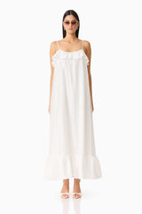 Brunette model wearing the CURAAE Estrella Maxi Dress in White front shot