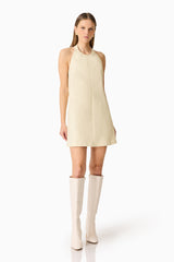 Brunette model wearing the Lavelle Halter Mini Dress in Lemon Yellow posed shot