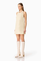 Brunette model wearing the Lavelle Halter Mini Dress in Lemon Yellow side shot
