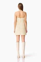 Brunette model wearing the Lavelle Halter Mini Dress in Lemon Yellow back shot