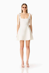 Brunette model wearing the Chantel Mini Dress in White front shot 
