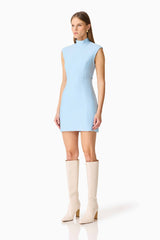 Brunette model wearing the Sacha Mini Dress in Baby Blue side shot 
