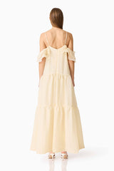Brunette model wearing the Maribelle Maxi Dress in Lemon Yellow back shot 