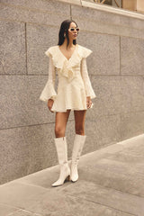 Brunette model wearing the Maribelle Long Sleeve Mini Dress in Lemon Yellow campaign shot