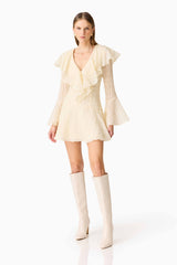 Brunette model wearing the Maribelle Long Sleeve Mini Dress in Lemon Yellow posed shot
