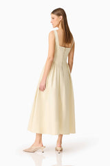 Brunette model wearing the Lavelle Maxi Dress in Lemon Yellow side back shot