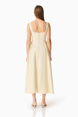 Brunette model wearing the Lavelle Maxi Dress in Lemon Yellow back shot