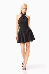 Blonde model wearing the Amaris Halter Mini Dress in Black posed shot 