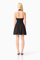 Blonde model wearing the Amaris Halter Mini Dress in Black back shot 