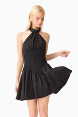 Blonde model wearing the Amaris Halter Mini Dress in Black close up shot 