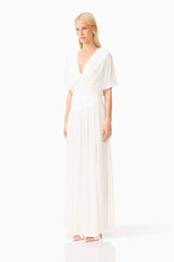 Blonde model wearing the CURAAE Amaris Maxi Dress in White side shot