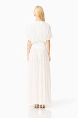 Blonde model wearing the CURAAE Amaris Maxi Dress in White back shot
