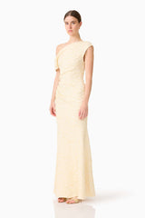Brunette model wearing the CURAAE Faye One Shoulder Maxi Dress in Cream side shot 